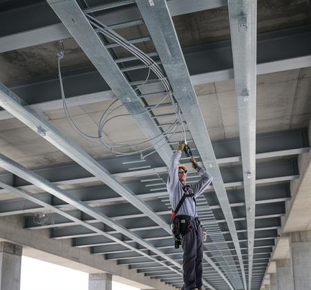Electrician installing a catenary wire rope kit